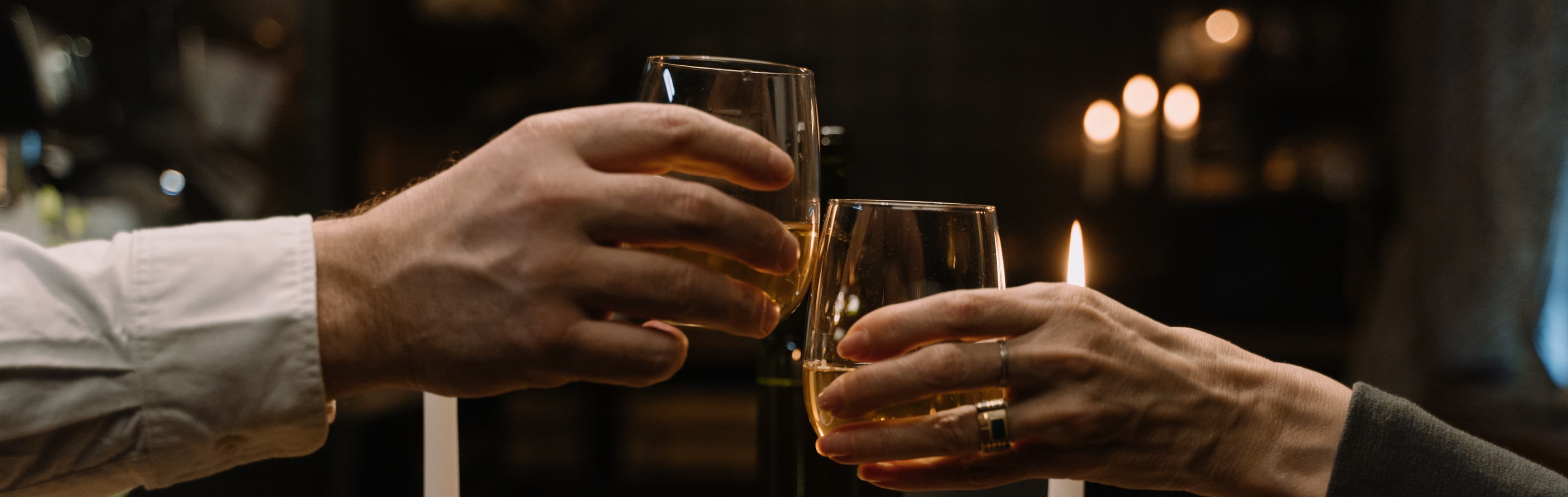 Two people clinking glasses of wine